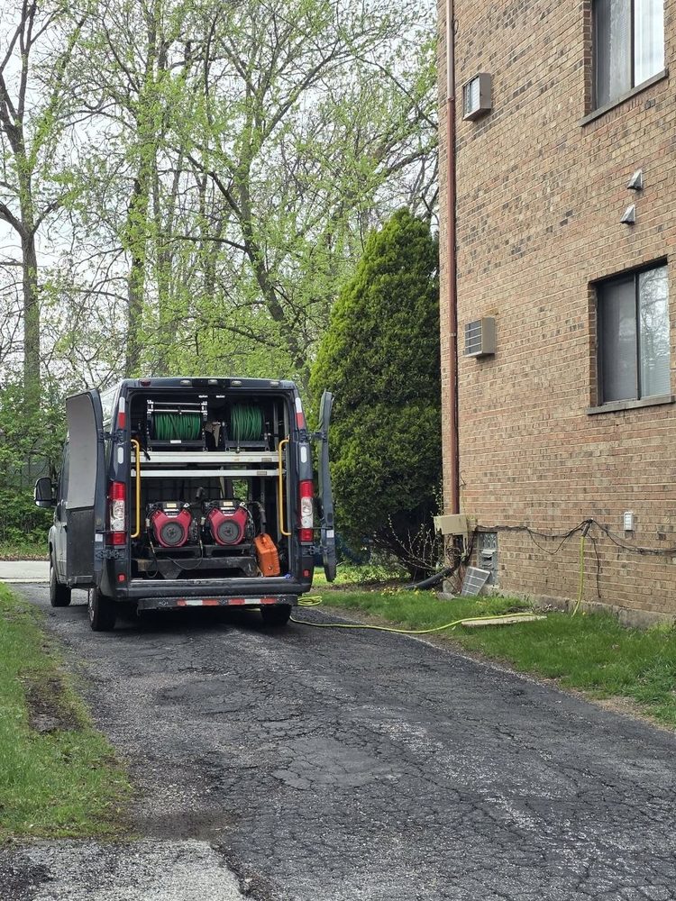 Hydro jetter rig ready to work from the van on a driveway