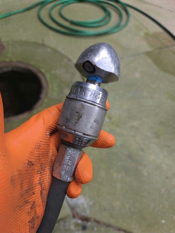 Warthog rotary hydro-jetting nozzle in a gloved hand