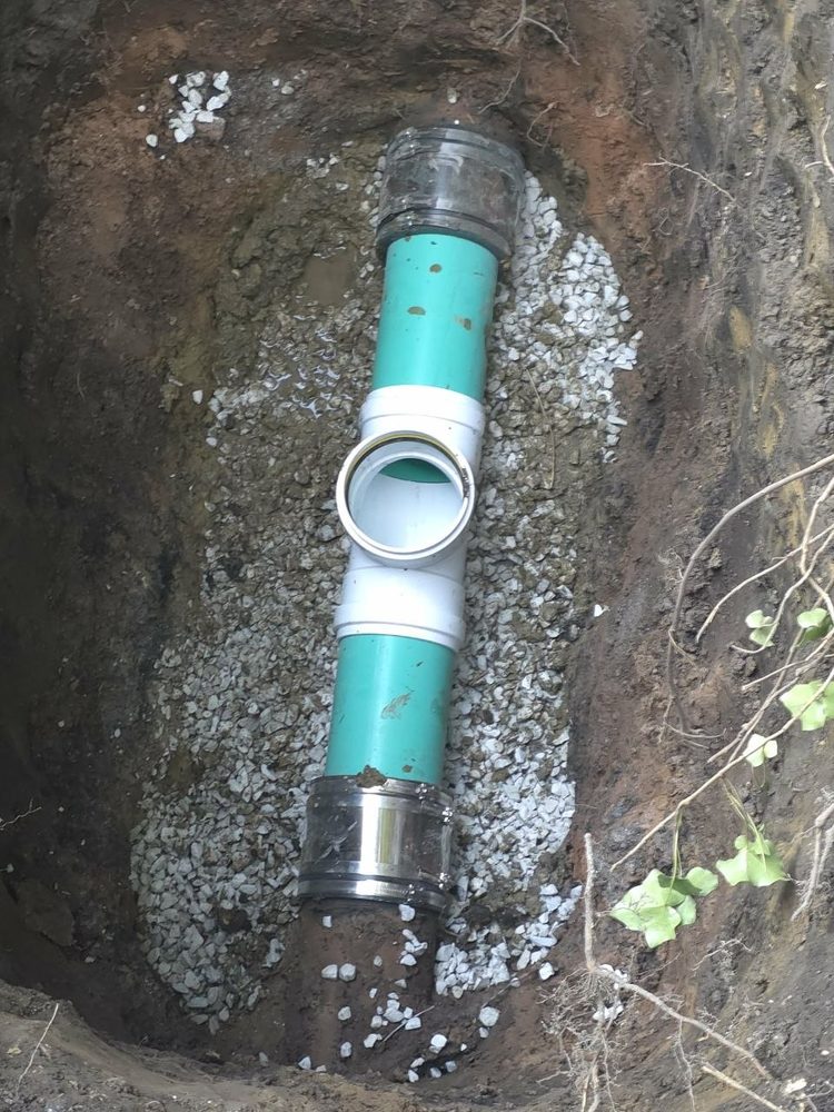 Sewer line spot repair in a trench with new PVC pipe